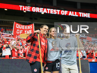 Sophie Schmidt, Christine Sinclair, and Erin McLeod take photos in front of fans during the International Friendly Match between Canada and...