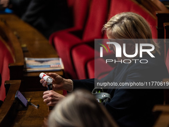 Rassemblement National leader Marine Le Pen refills her electronic cigarette between the benches of the Assemblee Nationale in Paris, France...