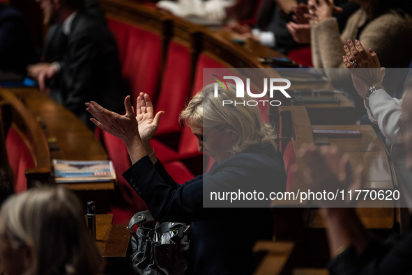 Rassemblement National leader Marine Le Pen stands between the benches of the Assemblee Nationale in Paris, France, on November 12, 2024. 