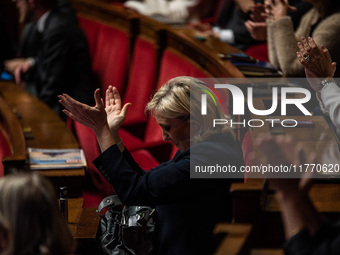 Rassemblement National leader Marine Le Pen stands between the benches of the Assemblee Nationale in Paris, France, on November 12, 2024. (