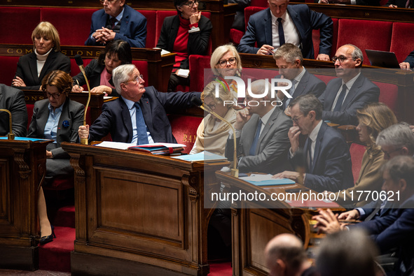 Michel Barnier and government ministers sit among the parliamentary benches during question time in Paris, France, on November 12, 2024. 