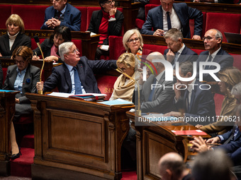 Michel Barnier and government ministers sit among the parliamentary benches during question time in Paris, France, on November 12, 2024. (