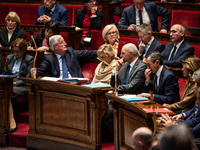 Michel Barnier and government ministers sit among the parliamentary benches during question time in Paris, France, on November 12, 2024. (