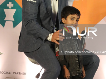 Norway's Magnus Carlsen poses with the world's youngest chess player, India's Anish Sarkar, during the 6th Tata Steel Chess India Rapid & Bl...