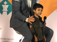 Norway's Magnus Carlsen poses with the world's youngest chess player, India's Anish Sarkar, during the 6th Tata Steel Chess India Rapid & Bl...