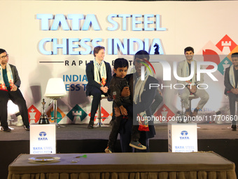 India's Rameshbabu Praggnanandhaa poses with the world's youngest chess player, India's Anish Sarkar, during the 6th Tata Steel Chess India...