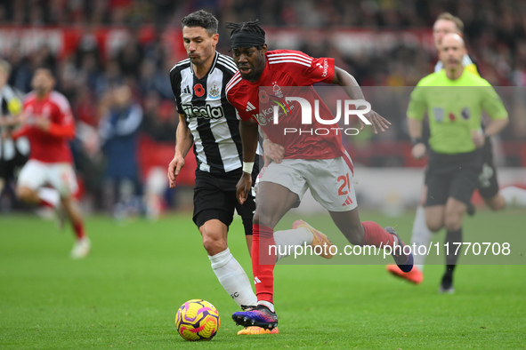 Anthony Elanga of Nottingham Forest is under pressure from Fabian Schar of Newcastle United during the Premier League match between Nottingh...