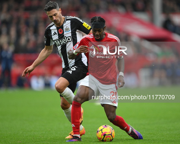 Anthony Elanga of Nottingham Forest is under pressure from Fabian Schar of Newcastle United during the Premier League match between Nottingh...