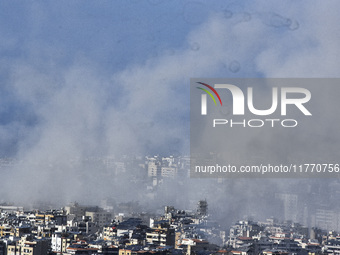 Smoke rises from the site of an Israeli airstrike that targets a neighborhood in Beirut's southern suburbs on November 12, 2024. (