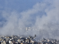 Smoke rises from the site of an Israeli airstrike that targets a neighborhood in Beirut's southern suburbs on November 12, 2024. (