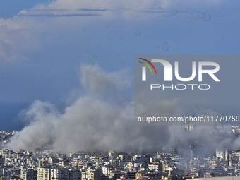 Smoke rises from the site of an Israeli airstrike that targets a neighborhood in Beirut's southern suburbs on November 12, 2024. (