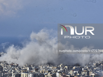 Smoke rises from the site of an Israeli airstrike that targets a neighborhood in Beirut's southern suburbs on November 12, 2024. (