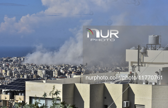 Smoke rises from the site of an Israeli airstrike that targets a neighborhood in Beirut's southern suburbs on November 12, 2024. 