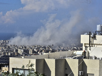 Smoke rises from the site of an Israeli airstrike that targets a neighborhood in Beirut's southern suburbs on November 12, 2024. (