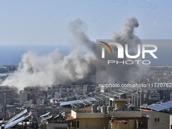 Smoke rises from the site of an Israeli airstrike that targets a neighborhood in Beirut's southern suburbs on November 12, 2024. (