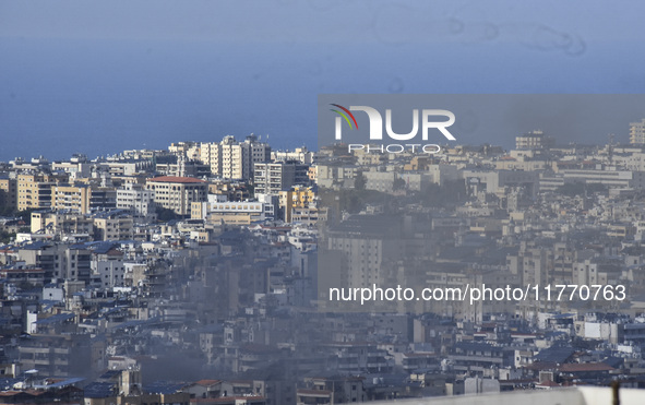 Smoke rises from the site of an Israeli airstrike that targets a neighborhood in Beirut's southern suburbs on November 12, 2024. 