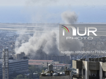 Smoke rises from the site of an Israeli airstrike that targets a neighborhood in Beirut's southern suburbs on November 12, 2024. (