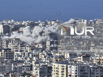 Smoke rises from the site of an Israeli airstrike that targets a neighborhood in Beirut's southern suburbs on November 12, 2024. (