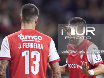 Joao Moutinho of SC Braga talks with Joao Ferreira of SC Braga during the Liga Portugal Betclic match between SC Braga and Sporting CP at Es...