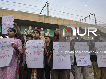 Dhaka University students protest the brutal murder of a female ready-made garment worker and demand justice at the Raju Memorial Sculpture...