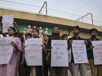 Dhaka University students protest the brutal murder of a female ready-made garment worker and demand justice at the Raju Memorial Sculpture...