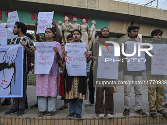 Dhaka University students protest the brutal murder of a female ready-made garment worker and demand justice at the Raju Memorial Sculpture...