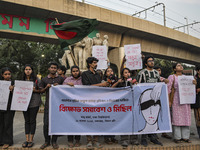 Dhaka University students protest the brutal murder of a female ready-made garment worker and demand justice at the Raju Memorial Sculpture...