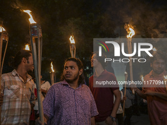 The Bangladesh Students Union holds a torch procession protesting the murder of a female ready-made garment worker and demanding justice in...