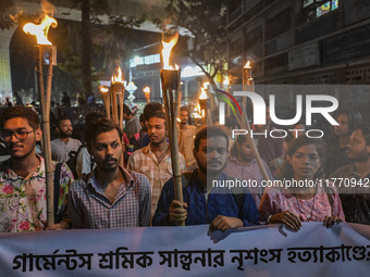 The Bangladesh Students Union holds a torch procession protesting the murder of a female ready-made garment worker and demanding justice in...