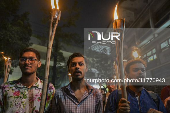 The Bangladesh Students Union holds a torch procession protesting the murder of a female ready-made garment worker and demanding justice in...