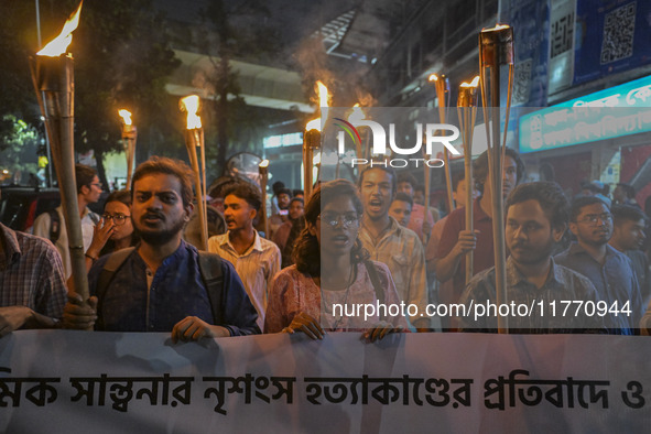 The Bangladesh Students Union holds a torch procession protesting the murder of a female ready-made garment worker and demanding justice in...