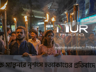 The Bangladesh Students Union holds a torch procession protesting the murder of a female ready-made garment worker and demanding justice in...