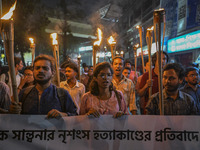 The Bangladesh Students Union holds a torch procession protesting the murder of a female ready-made garment worker and demanding justice in...