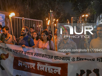 The Bangladesh Students Union holds a torch procession protesting the murder of a female ready-made garment worker and demanding justice in...