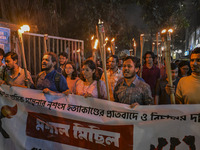 The Bangladesh Students Union holds a torch procession protesting the murder of a female ready-made garment worker and demanding justice in...