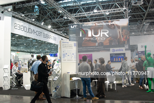 Fairgoers are seen at the WT wearable technology booth at Medica 2024 at the Duesseldorf exhibition center in Duesseldorf, Germany, on Novem...