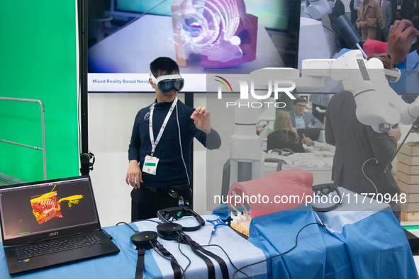 A fairgoer tries out VR surgery training, the medical technology at the Bonn University Hospital booth, at Medica 2024 at the Duesseldorf Ex...