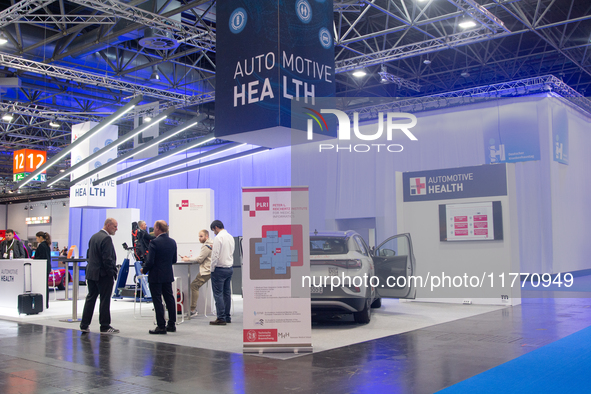 Fairgoers are seen at the Auto Health booth at Medica 2024 at the Duesseldorf exhibition center in Duesseldorf, Germany, on November 12, 202...