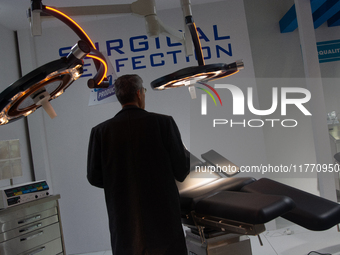 A fairgoer looks at a surgical chair at the Duesseldorf Exhibition Center in Duesseldorf, Germany, on November 12, 2024, during MEDICA 2024....