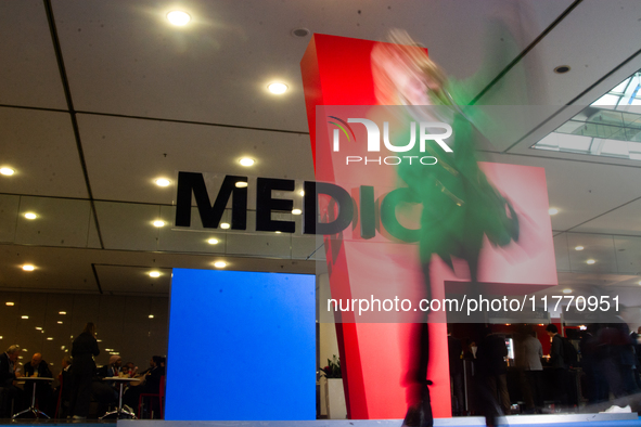 A fairgoer walks past the Medica installation at the Duesseldorf Exhibition Center in Duesseldorf, Germany, on November 12, 2024, during MED...