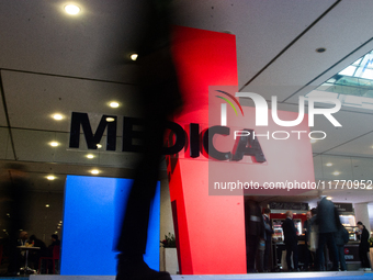 A fairgoer walks past the Medica installation at the Duesseldorf Exhibition Center in Duesseldorf, Germany, on November 12, 2024, during MED...