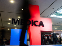 A fairgoer walks past the Medica installation at the Duesseldorf Exhibition Center in Duesseldorf, Germany, on November 12, 2024, during MED...