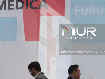 Fairgoers walk past the MEDICA logo at Medica 2024 at the Duesseldorf Exhibition Center in Duesseldorf, Germany, on November 12, 2024. (