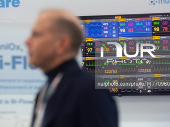 A fairgoer walks past a medical monitor at Medica 2024 at the Duesseldorf exhibition center in Duesseldorf, Germany, on November 12, 2024. (