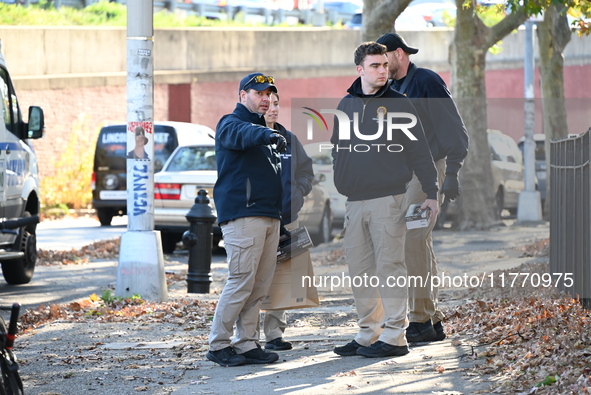 Evidence markers indicate where blood and other evidence is found after a 21-year-old man is fatally stabbed at Steuben Park in Brooklyn, Ne...