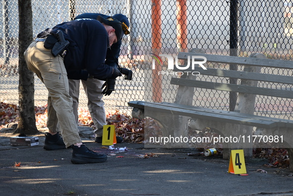 Evidence markers indicate where blood and other evidence is found after a 21-year-old man is fatally stabbed at Steuben Park in Brooklyn, Ne...