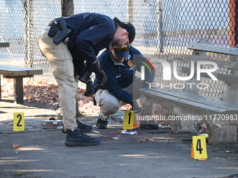 Evidence markers indicate where blood and other evidence is found after a 21-year-old man is fatally stabbed at Steuben Park in Brooklyn, Ne...