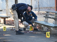 Evidence markers indicate where blood and other evidence is found after a 21-year-old man is fatally stabbed at Steuben Park in Brooklyn, Ne...