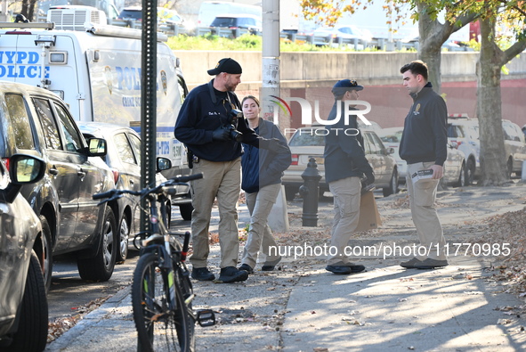 Evidence markers indicate where blood and other evidence is found after a 21-year-old man is fatally stabbed at Steuben Park in Brooklyn, Ne...