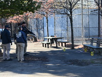 Evidence markers indicate where blood and other evidence is found after a 21-year-old man is fatally stabbed at Steuben Park in Brooklyn, Ne...